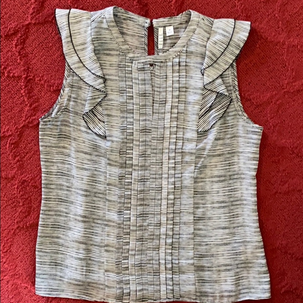Black and white sleeveless blouse.